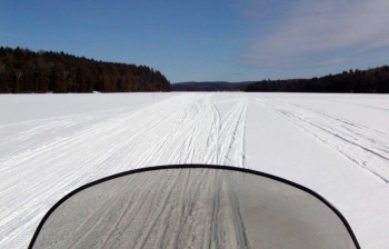 Snwomobiling on winter lake